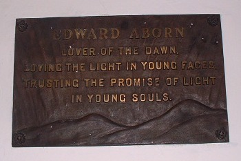 tablet reading: Edward Aborn: Lover of the dawn, loving the light in 
young faces, trusting the promise of light in young souls.